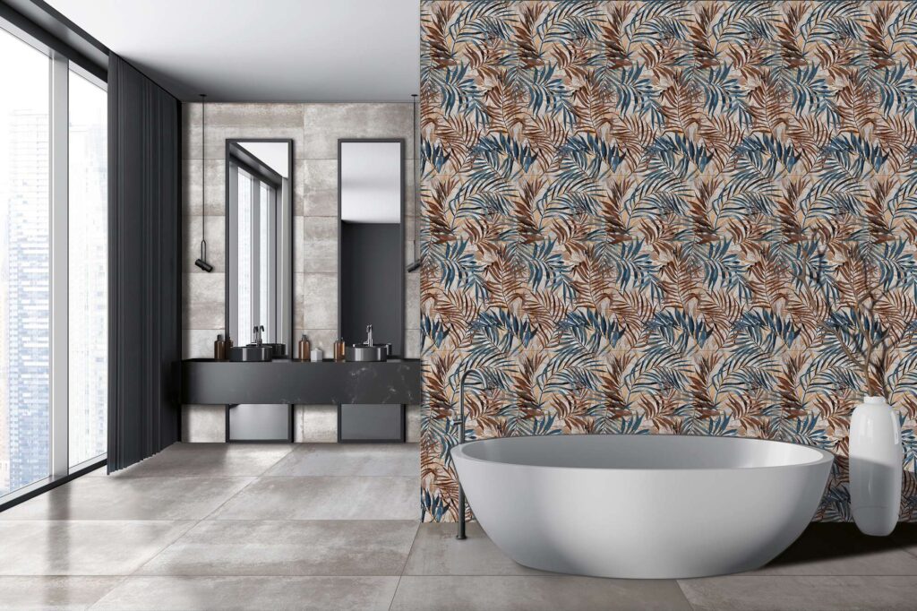 La collezione HEMISPHERE colore STEEL 60x120 riveste con eleganza questo ambiente bagno di design, qui presentato in abbinamento al decoro botanico DEC. SAVAGE. In primo piano, una moderna vasca da bagno freestanding bianca si staglia contro una scenografica parete d'accento, decorata con un fitto motivo di foglie tropicali nei toni caldi del ruggine e del blu. Il pavimento e la parete retrostante, che ospita un mobile lavabo con doppi specchi neri, sono rivestiti con le piastrelle in gres porcellanato effetto metallo grigio Hemisphere Steel, inondate dalla luce naturale di una grande vetrata panoramica.
